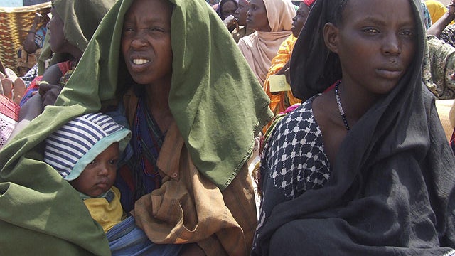 Somali women displaced by drought, wait to receive rations at a camp in Mogadishu, Somalia, July 20, 2011.  