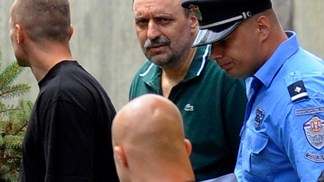 Goran Hadzic, center back in green shirt, arrives July 22, 2011, at the house where he lived in Novi Sad, Serbia, before he went into hiding in 2004. Serbian authorities tracked down the war-crimes fugitive in the northern mountains July 20, 2011, arresti 