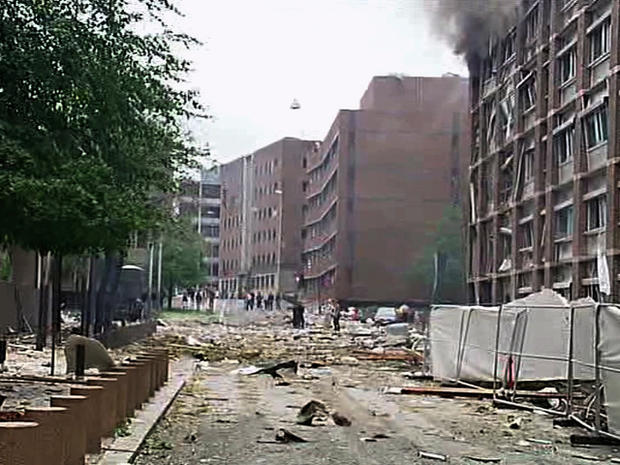 damaged building as debris is strewn across the street after an explosion in Oslo 