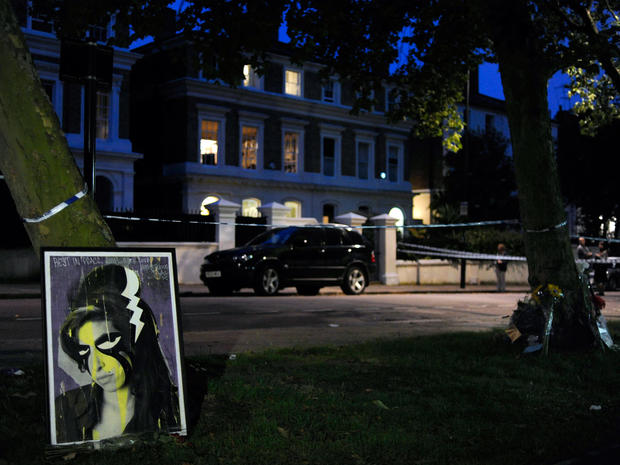 A painting of Amy Winehouse is left near the house in north London where the body of the English pop star was found earlier on July 23 2011.  