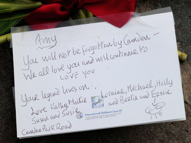 A note is left near the house in north London where the body of English pop star Amy Winehouse was found earlier in the day, on July 23 2011.  