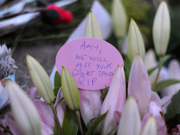 Flowers and notes are left near the house in north London where the body of English pop star Amy Winehouse was found  on July 23, 2011. 