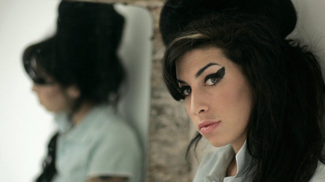 British singer Amy Winehouse poses for photographs after being interviewed by The Associated Press  