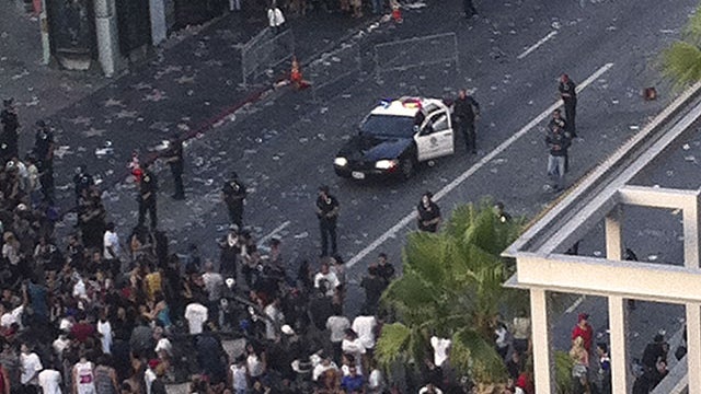 Police hold back a crowd outside Grauman's Chinese Theater in the Hollywood section of Los Angeles Wednesday July 27, 2011 after a crowd became unruly outside the Hollywood film premiere of a documentary about the Electric Daisy Carnival rave, throwing bo 