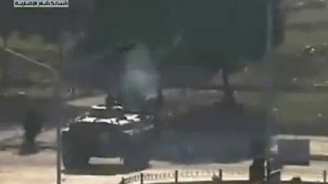 In this image posted on the Internet by Shaam News Network, showing what they purport to be a military tank on the streets of the city of Hama, Syria, on the "third day of Ramadan", Wednesday Aug. 3, 2011.  