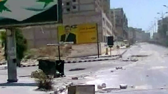 Empty streets with debris are shown Aug. 4, 2011, in what the Syrian official news agency SANA describes as the Syrian army restoring "security and stability" to the central city of Hama, Syria. Syrian security forces pounded the city of Hama with tank sh 
