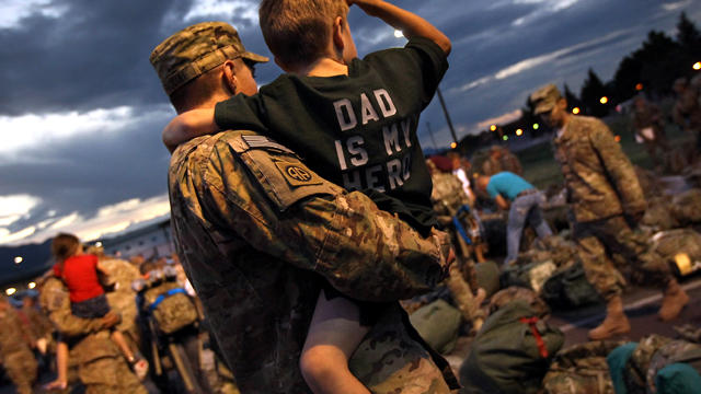 Sgt. Matt Puccini carries his son Gavin, 4, during a welcome home ceremony for U.S. Army troops returning from Afghanistan July 9, 2011, in Fort Carson, Colo. Some 530 soldiers from the 1st Brigade Combat Team were arriving over the course of a weekend, t 