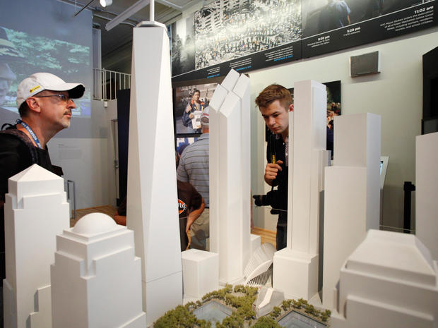 Tourists look at a scale model of the proposed World Trade Center at the 9/11 Memorial Preview Site in New York  