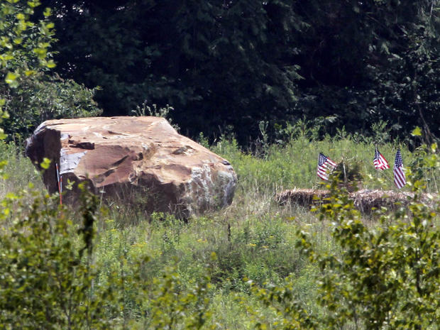 The 17-ton boulder, left, that was placed to mark the site of the crash of Flight 93 at the Flight 93 Memorial in Shanksville, Pa. 