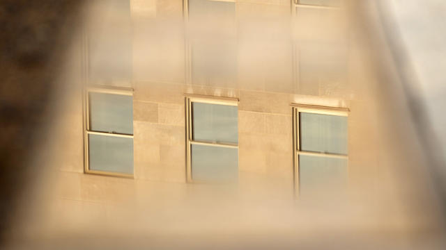 Windows of the Pentagon are reflected on one of the 184 stone benches outside the Pentagon in Arlington, Va. 