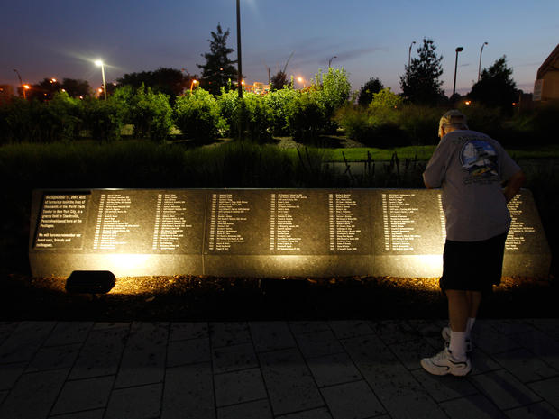 a visitor to the Pentagon Memorial reads the names of people who died Sept. 11, 2001, in the terrorist attack on the Pentagon in Arlington, Va. 