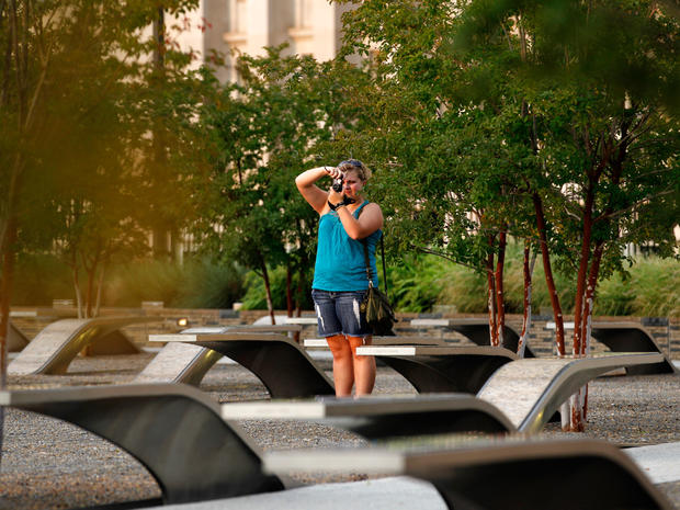 A visitor takes pictures at the permanent outdoor Pentagon Memorial in Arlington Va. 
