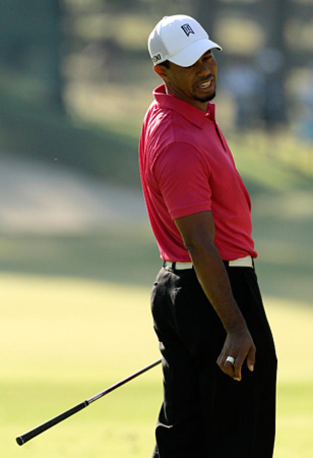 Tiger Woods reacts to an approach shot 