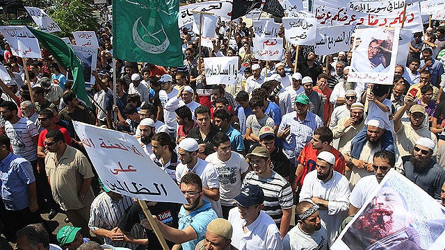 Anti-Syrian regime protesters protest after the Friday prayer to show their support for the Syrian protesters who demonstrate against President Bashar Assad, in the southern port city of Sidon, Lebanon, Aug. 12, 2011.  