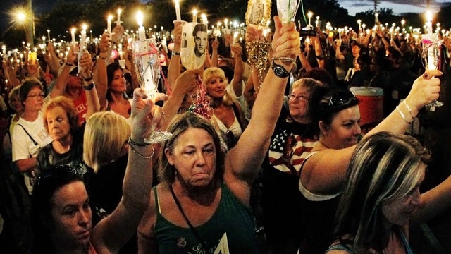 Elvis fans mourn at a vigil marking the 34th anniversary of his death 
