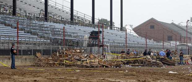 Indiana State Police and authorities survey the collapsed rigging and Sugarland stage on the infield at the Indiana State Fair in Indianapolis, Sunday, Aug. 14, 2011.  