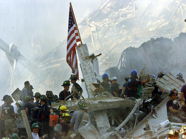 An American flag flies over the rubble of the collapsed World Trade Center buildings in New York Sept. 13, 2001. 