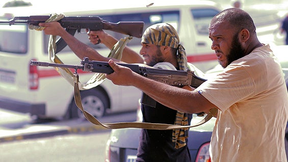 Libyan rebel fighters shoot toward pro-Qaddafi forces during fighting in downtown Tripoli, Libya, Aug. 22, 2011. Libyan rebels claimed to be in control of most of the Libyan capital after their lightning advance on Tripoli heralded the fall of Muammar Qad 