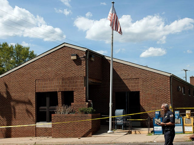 Delbert Feaster with Louisa County Fire and EMS walks the perimeter of the Mineral Virginia Post Office after is was closed from structural damage during an earthquake Aug. 23, 2001, in Mineral, Va. 