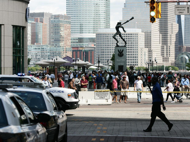 People stand outside after a temporary evacuation from office buildings in Jersey City, N.J., Aug. 23, 2011. 