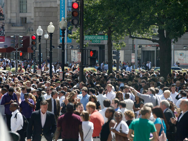 People crowd Pennsylvania Avenue in Washington, Tuesday, Aug. 23, 2011, as they evacuate buildings after an earthquake in the Washington area. 