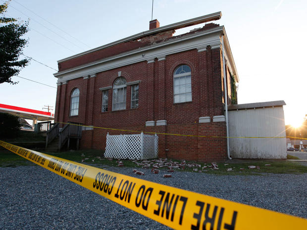 The sun sets behind a quake damaged building in Mineral, Va., a small town close to the epicenter,  Aug. 23, 2011. 