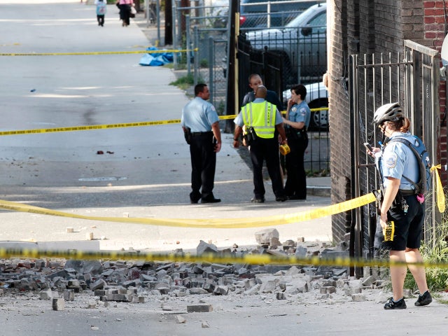 Police block off the alley behind the Embassy of Ecuador in Washington after part of the building sustained damages, after a earthquake in the Washington area.  