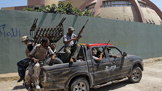 Rebel fighters seen inside the main Moammar Gadhafi compound in Bab al-Aziziya in Tripoli, Libya, Aug. 24, 2011.  