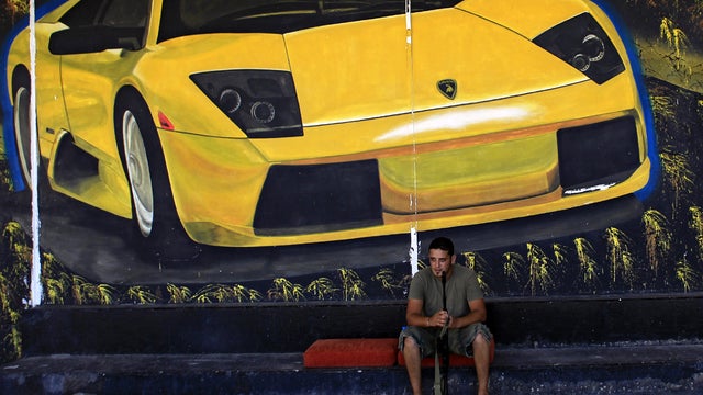 Rebel at Al-Saadi Qaddafi's looted home 