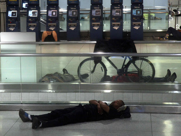 People sleep at Penn Station in New York 