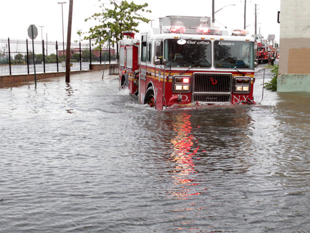 A fire truck drives through a flooded street in Brooklyn 