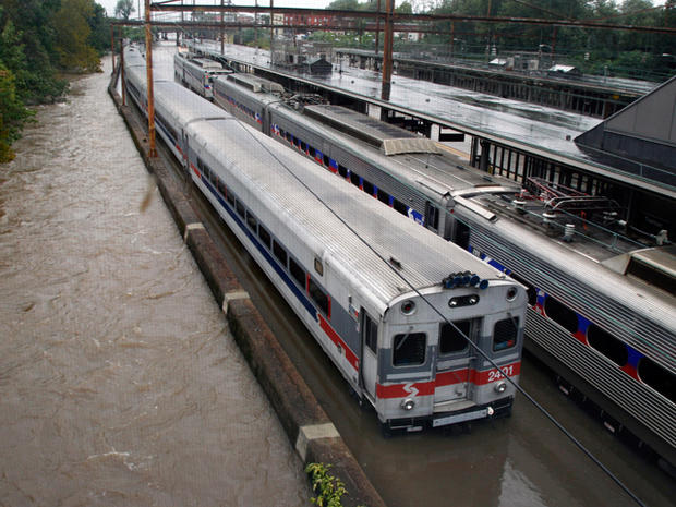 trains sit in water on flooded tracks  
