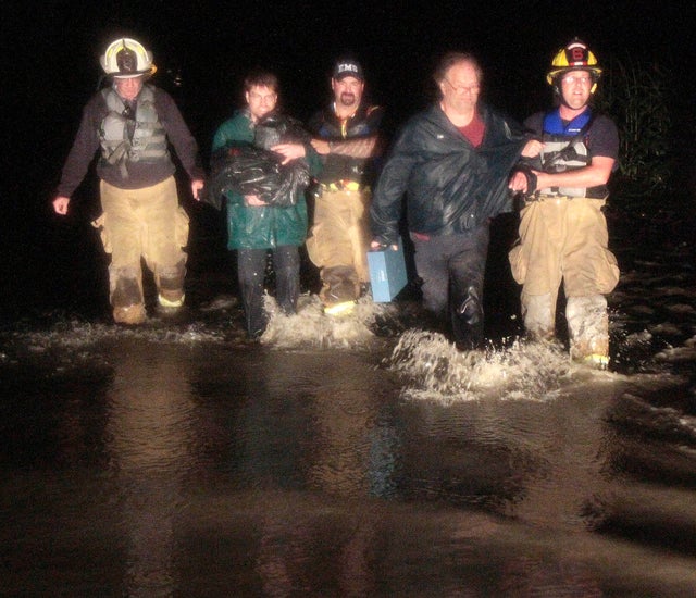 Rescue personnel bring stranded residents to shore on Sunday, Aug. 28, 2011, in Montpelier, Vt.  