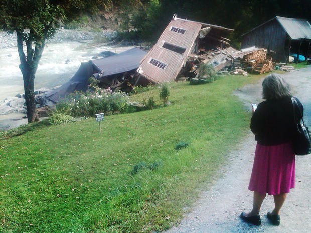 Helen Wachtel, 57, of South Newfane, Vt., looks at the ruins of a former grist mill in Newfane, Vt. 
