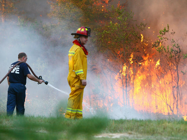 Fire fighters battle a wildfire in Porter, Texas 