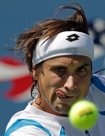 David Ferrer of Spain returns a shot  