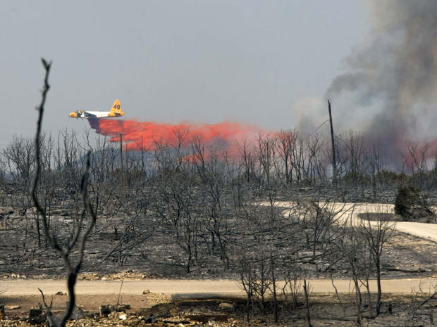 An air tanker drops fire retardant on a fire near Possum Kingdom Lake 
