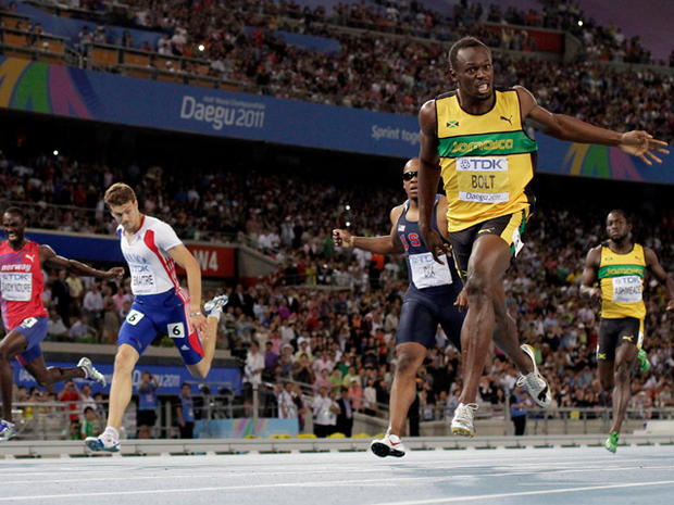 Usain Bolt crosses the finish line 