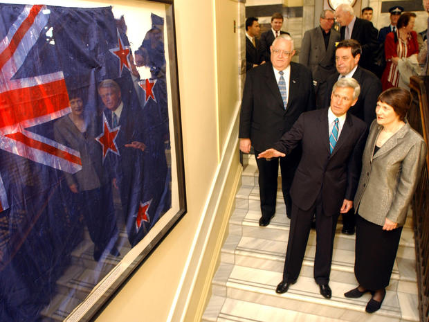 American Ambassador Charles Swindells and New Zealand Prime Minister Helen Clark view in Wellington, New Zealand, April 30, 2002, the ground zero flag recovered from New York's Twin Towers disaster site. The flag, which had been stored in an underground l 