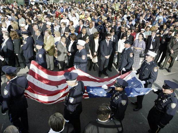 The flag which flew above the World Trade Center is carried to the stage during ceremonies marking the third anniversary of the 9/11 terrorist attacks at ground zero Sept. 11, 2004, in New York City. 