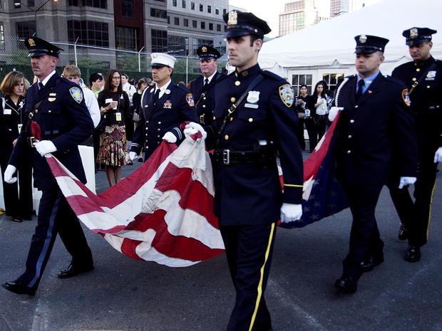 Police officers and firefighters carry the U.S. flag that flew over ground zero until late October 2001 during a ceremony Sept. 11, 2005, in New York City to commemorate the Sept. 11, 2001, attacks. 