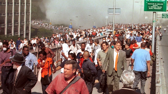 People flee Lower Manhattan across the Brooklyn Bridge in New York after a terrorist attack on the World Trade Center Sept. 11, 2001. 