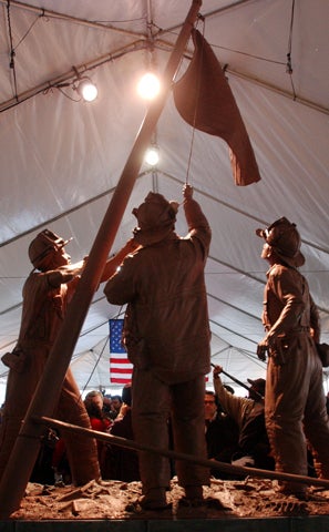 A clay model of the sculpture titled "Flag Raising At Ground Zero" is seen shortly after its unveiling Dec. 21, 2001, in Brooklyn, N.Y. The sculpture was planned to stand 18 feet high outside New York Fire Department headquarters in Downtown Brooklyn. The 