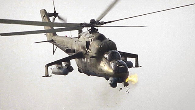 An Afghan military helicopter fires on a building which is occupied by Taliban insurgents during a coordinated assault in Kabul, Afghanistan, on Sept. 13, 2011.  
