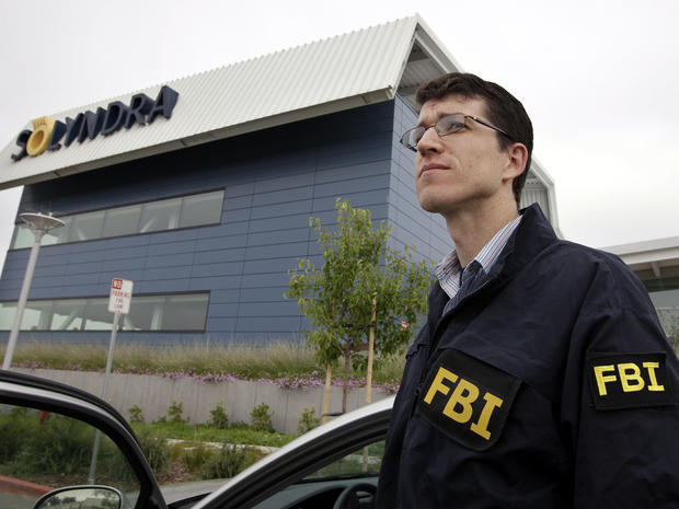 An FBI agent stands guard outside of Solyndra headquarters in Fremont, Calif., Sept. 8, 2011, while the bureau was executing search warrants at the headquarters of the solar firm that received a $535 million loan from the federal government. 