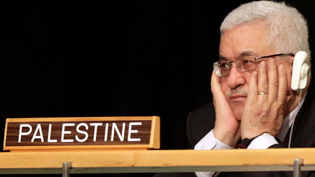 Palestinian President Mahmoud Abbas holds his hands to his face as President Obama speaks during the 66th session of the General Assembly at United Nations headquarters Sept. 21, 2011. 