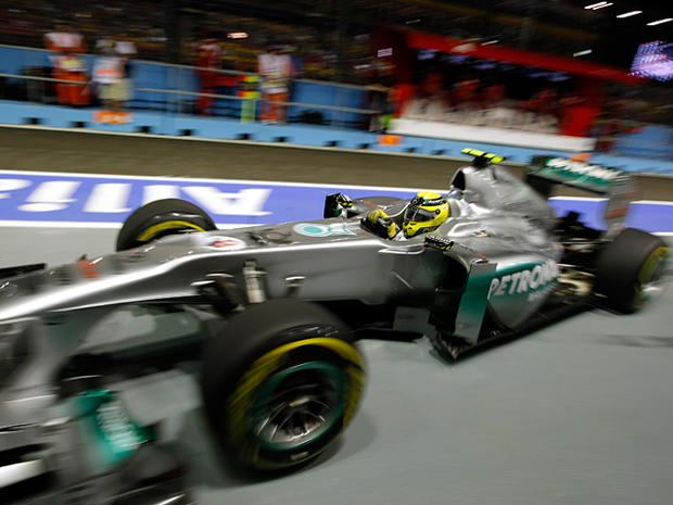Nico Rosberg steers his car out of his garage 