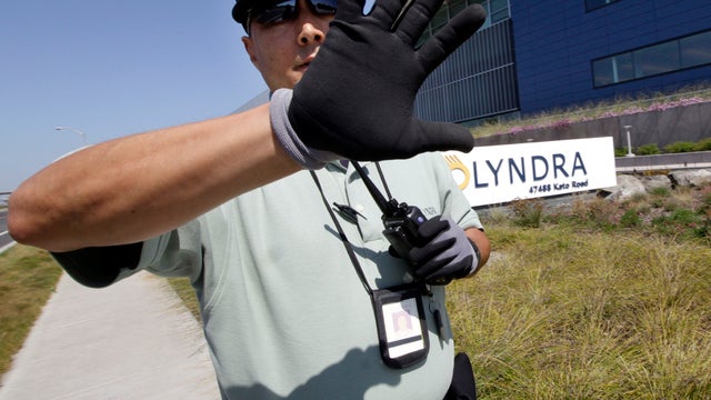 A security guard blocks a picture of the bankrupt California solar energy company Solyndra in a public area in Fremont, Calif., Sept. 16, 2011. The Obama administration was worried about the financial health of Solyndra and the political fallout it could  