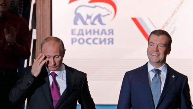 Russian President Dmitry Medvedev, right, and Prime Minister Vladimir Putin arrive to attend a United Russia party congress in Moscow on Saturday 