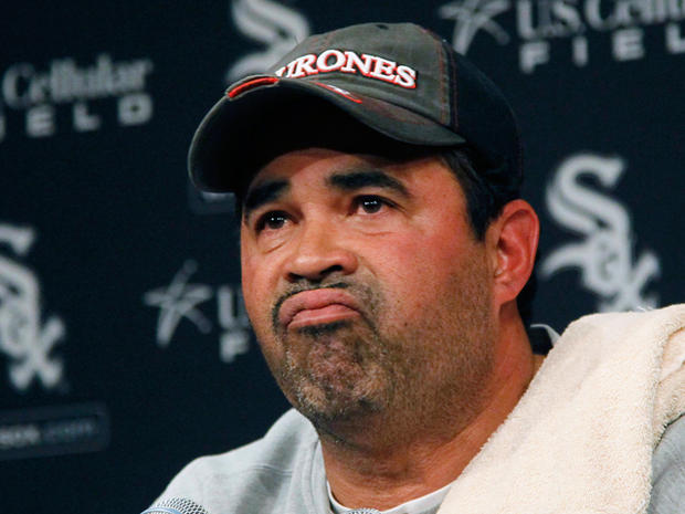 Ozzie Guillen pauses during a news conference  